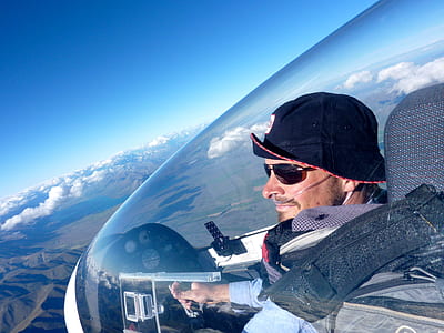 man in black bucket hat driving plane during daytime thumbnail