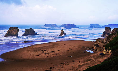 brown sand with body water during daytime thumbnail