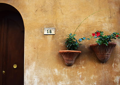 two brown ceramic wall vases near door thumbnail