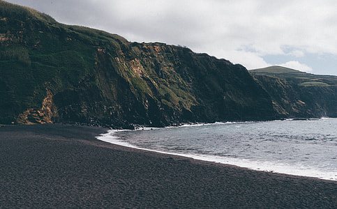 mountain rock near seashore thumbnail