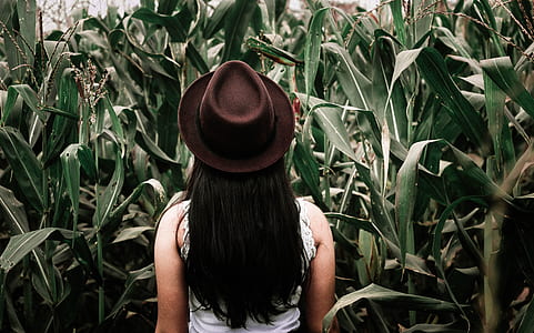 woman in white sleeveless top wearing brown hat thumbnail