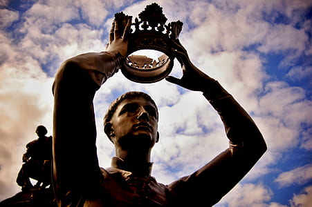 man holding crown statue thumbnail