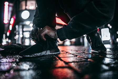 man wearing black-and-white adidas sneakers thumbnail