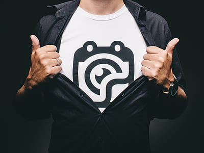 man in black button-up dress shirt and white and black crew-neck top thumbnail