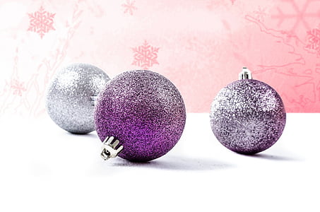 close-up photo of purple and gray glittered baubles on white surface thumbnail