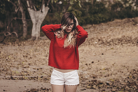 selective focus photography of woman holding her hair thumbnail