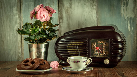 black vintage radio and white ceramic cup with saucer on brown surface thumbnail