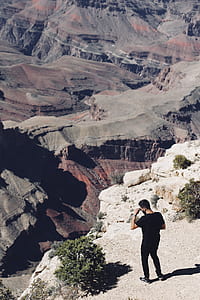 man standing near cliff during daytime thumbnail