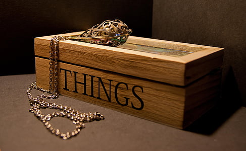 gold necklace on brown wooden Things-printed box thumbnail
