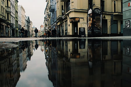 Reflection Of Buildings On Puddle thumbnail