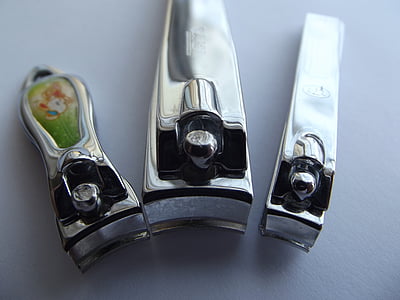 three gray stainless steel nail clippers on white surface thumbnail