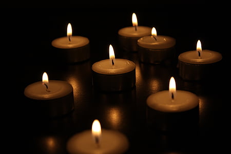 lit gray tealight candles closeup photography thumbnail