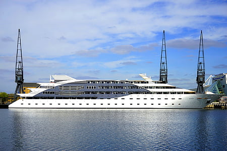 white and blue cruise ship on body of water under blue sky thumbnail