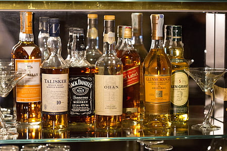 liquor bottles on glass shelf thumbnail