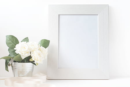 photo frame beside potted white flower thumbnail