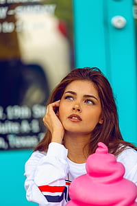 woman holding her face with blue background thumbnail