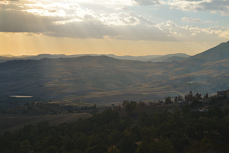landscape photo of sun ray directed to green trees and mountains thumbnail