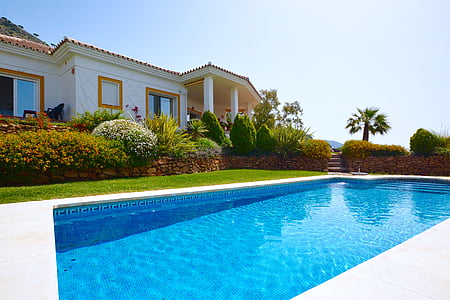 white concrete house beside in ground pool thumbnail
