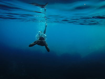 man diving on calm body of water thumbnail