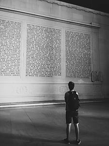 man staring at a wall with writing thumbnail