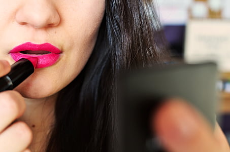 woman putting on pink lipstick thumbnail