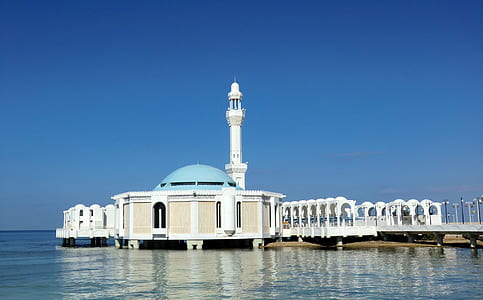 white and blue mosque beside body of water thumbnail