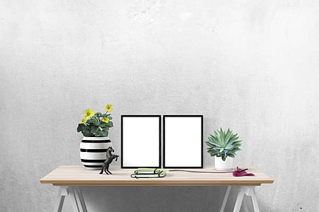 black and white ceramic flower vase on beige table thumbnail
