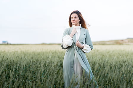 woman wearing bathrobe standing on green grass field thumbnail