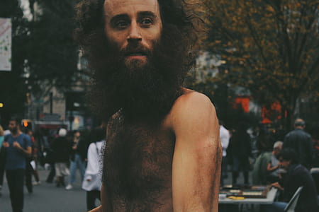 topless man walking on street thumbnail