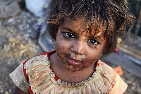 close up photo of girl wearing brown shirt with face covered with dirt thumbnail