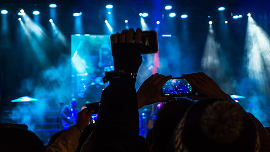 group of people holding smartphones watching concert thumbnail