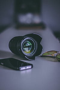 selective focus photography of lens and phone thumbnail