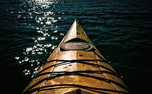 yellow kayak on body of water thumbnail