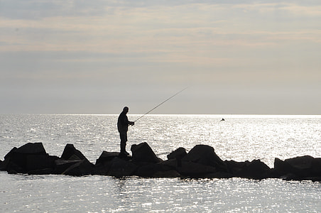 silhouette of man fishing thumbnail