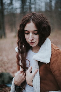 woman standing near trees in tilt shift lens photography thumbnail