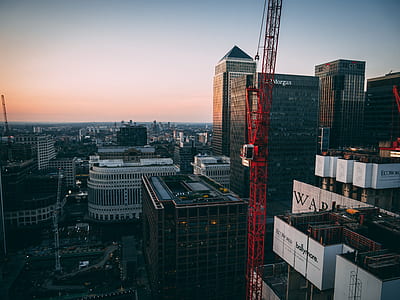 aerial photography of city buildings and tower crane thumbnail