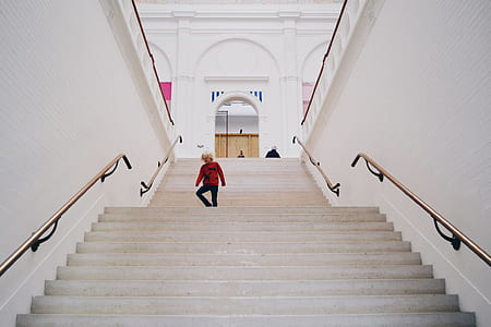 boy walking on gray concrete stairway thumbnail
