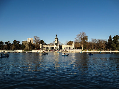 assorted-color boats on body of water under blue sky thumbnail