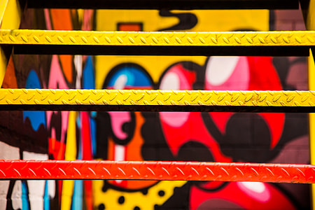 closeup photo of red, yellow, and black wall graffiti thumbnail