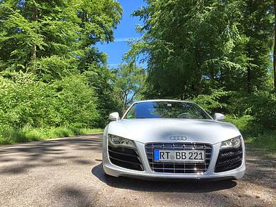 white Audi vehicle near green leafed trees under clear blue sky during daytime thumbnail