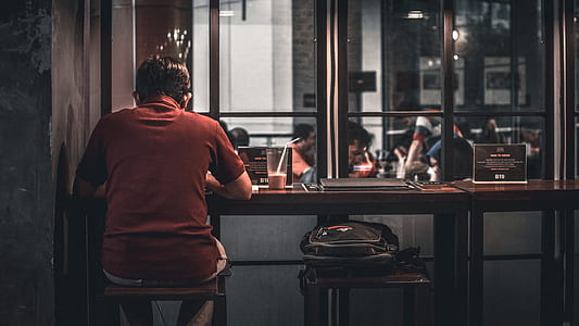 person sitting on brown bar stool thumbnail