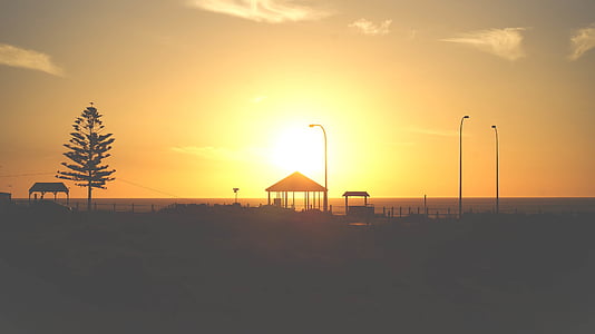 silhouette of pergola under golden sky thumbnail