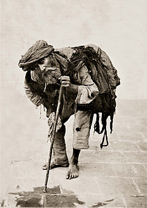 grayscale photo of man with stick thumbnail