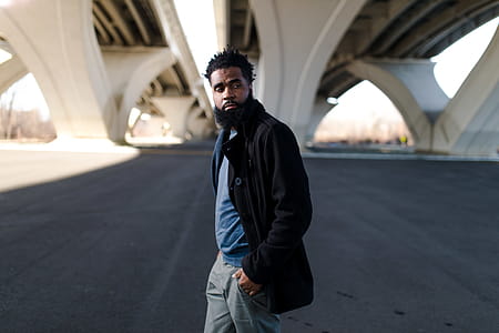 Man Wearing Black Long Jacket and Blue Shirt Holding Pocket thumbnail