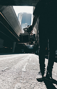 person holding video recorder standing on road during daytime thumbnail