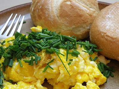 omelet with vegetable toppings and baked breads thumbnail