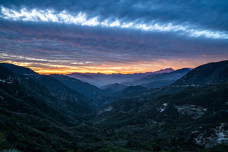 aerial photography of green mountain under clouds thumbnail