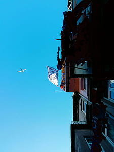 low-angle of building and plane flying thumbnail