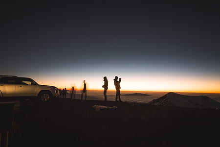 silhouette of four person standing on hill thumbnail