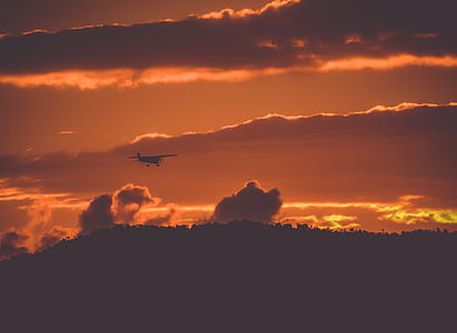 silhouette photo of flying plane thumbnail